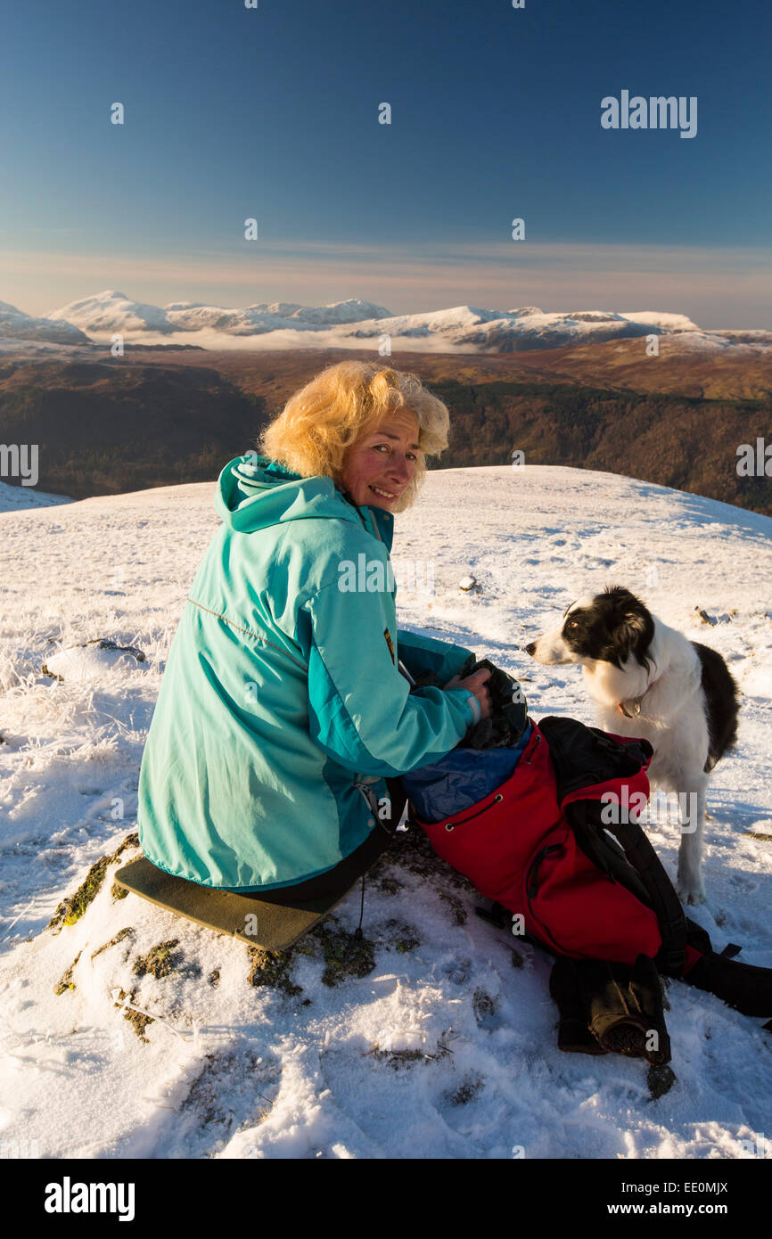 A woman walker and dog on the Helvellyn Range in the Lake District, UK in winter Stock Photo