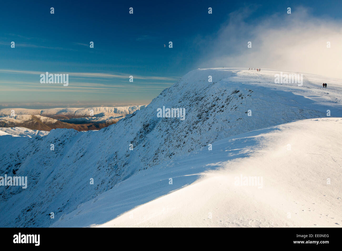 Walkers on Helvellyn summit in winter conditions, Lake District, UK. Stock Photo