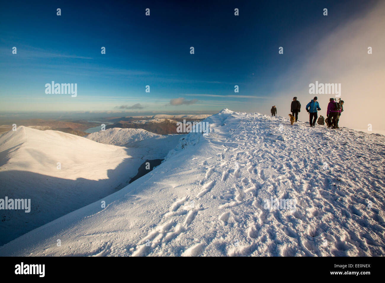 Walkers on Helvellyn summit in winter conditions, Lake District, UK. Stock Photo