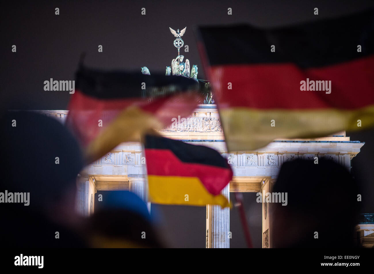 Berlin, Germany. 12th Jan, 2015. Members of the 'Baergida' (Berlin Patriots against the Islamization of the west) alliance, an off-shoot of the 'Pegida' (Patriotic Europeans Against the Islamization of the West) movement, protest with German flags in front of the Brandenburg Gate in Berlin, Germany, 12 January 2015. For weeks the anti-Islamic, right-wing populist movement Pegida has been organizing demonstrations against supposed foreign infiltration in various cities. Photo: BERND VON JUTRCZENKA/dpa/Alamy Live News Stock Photo
