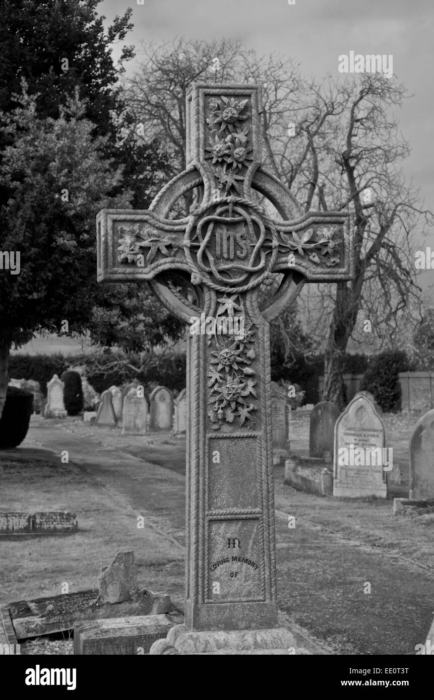 Ornate Celtic cross gravestone with Christogram. Monochrome Stock Photo