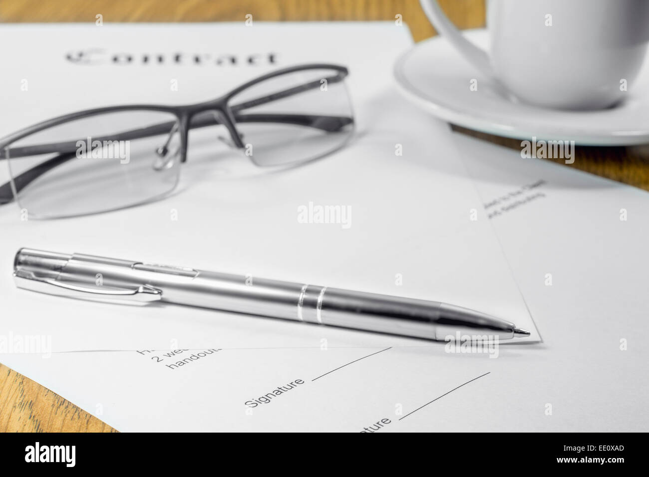 contract business papers pen glasses cup of coffee Stock Photo