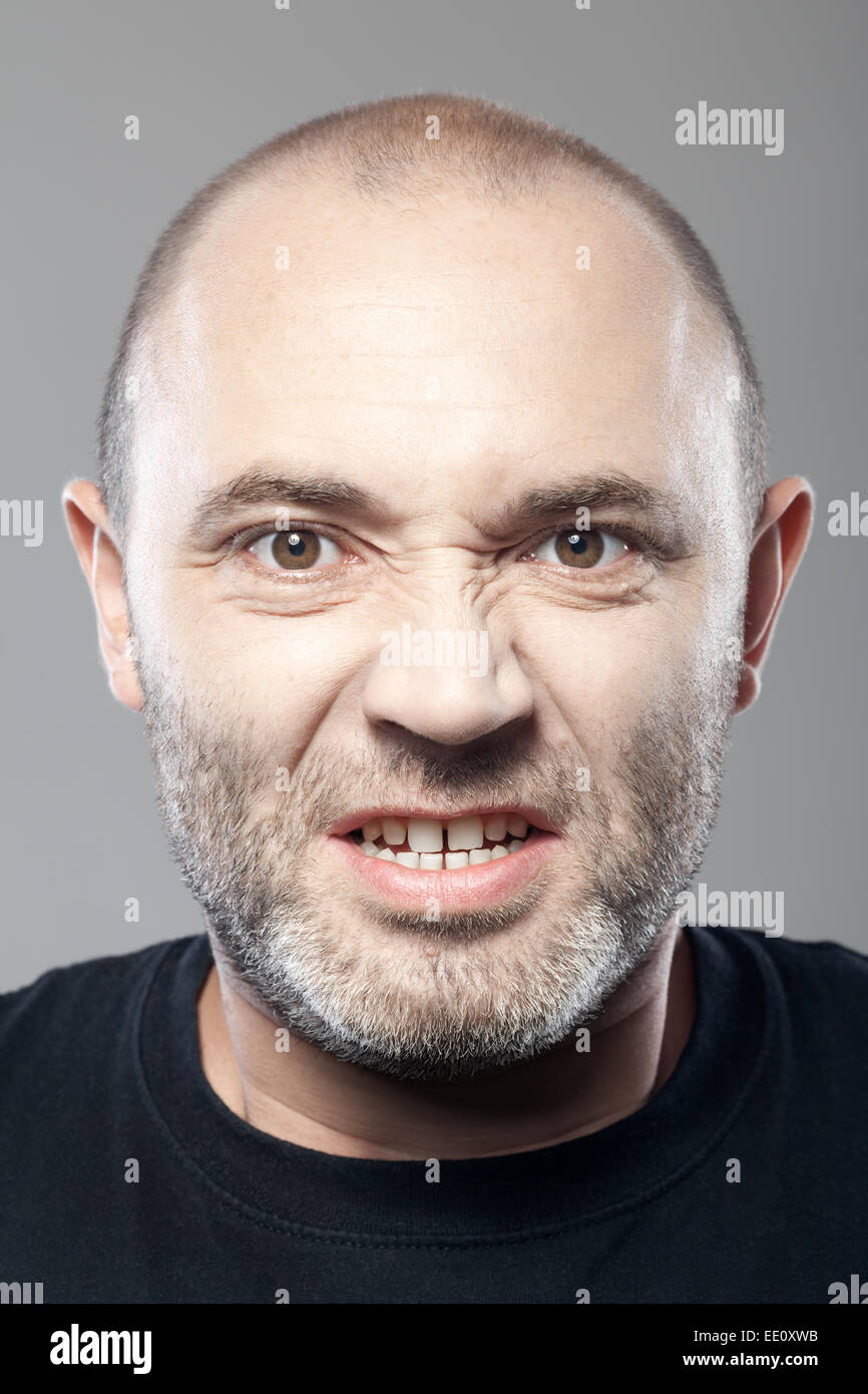 portrait of angry man isolated on gray background Stock Photo