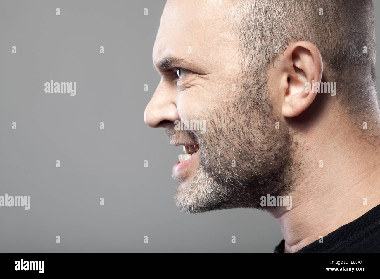 portrait of angry man isolated on gray background with copyspace Stock Photo