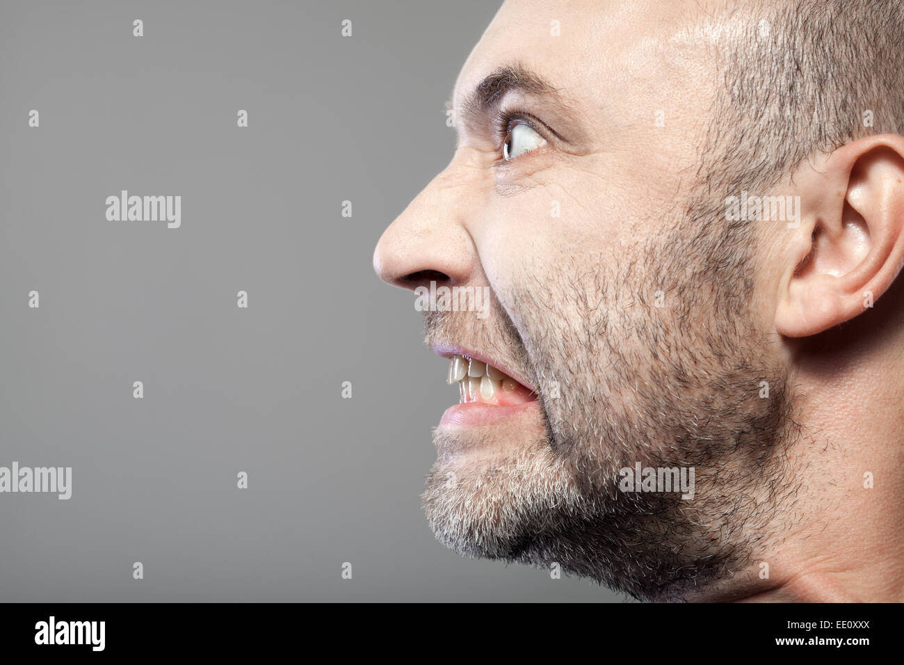 portrait of angry man isolated on gray background with copyspace Stock Photo