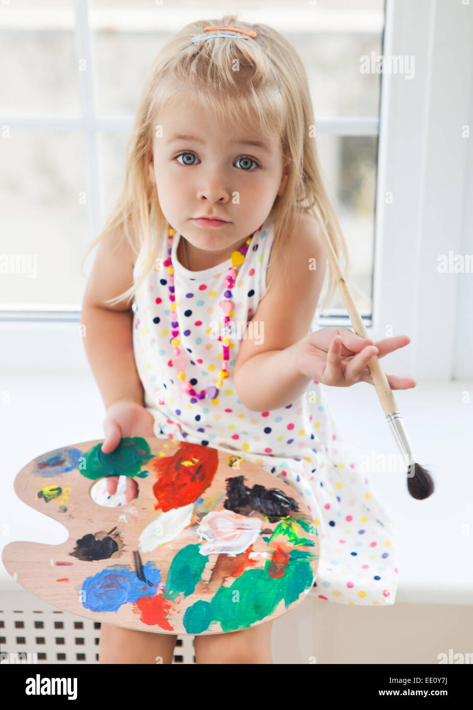 Cute little girl drawing paints holding palette and brush Stock Photo ...