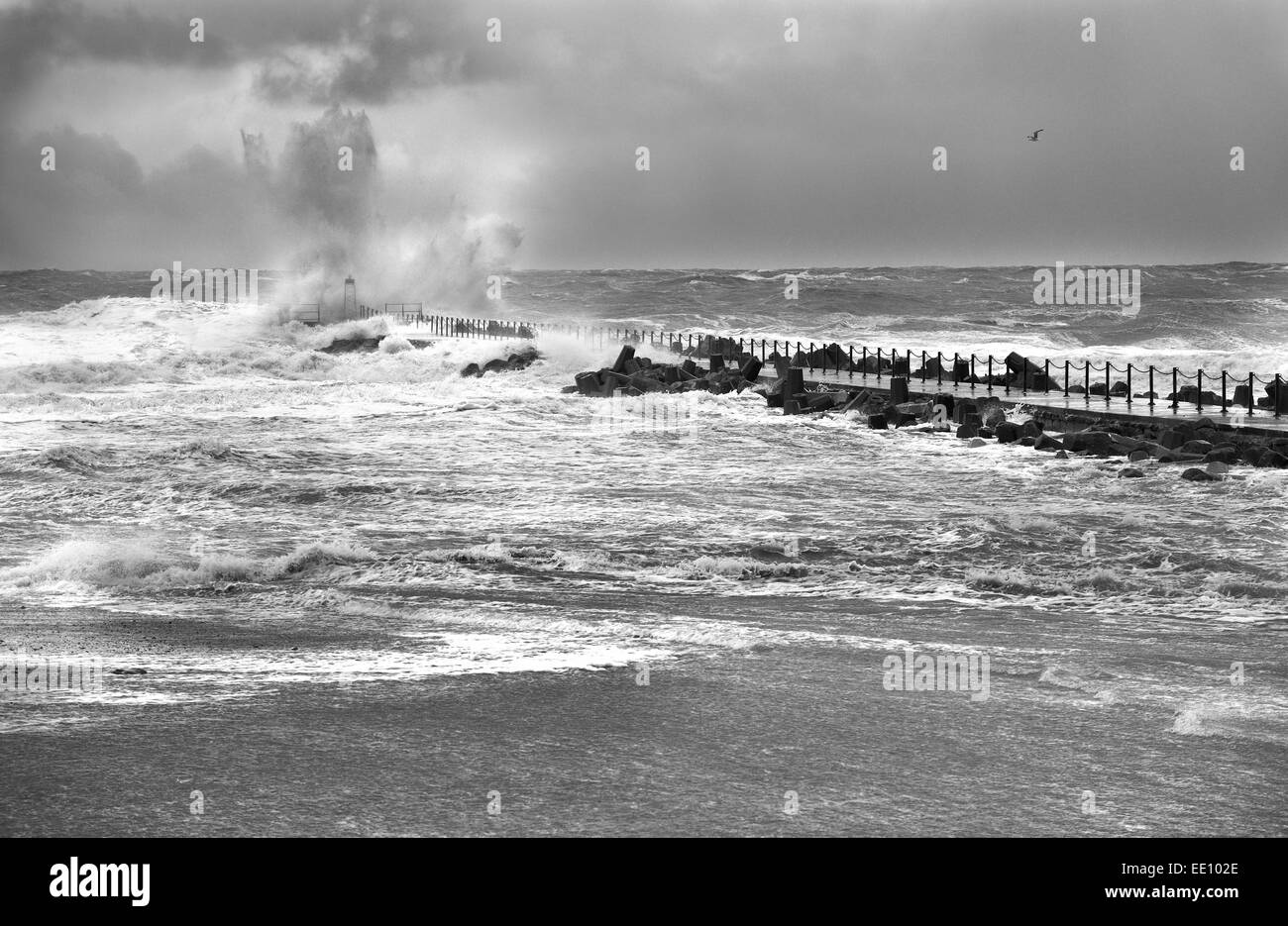 Nr. Vorupoer, Denmark. 12th January, 2015. Strong winds with a speed of 25 m/s  causes waves to smash against the pier of the harbour entrance. The storm has caused flooding in costal areas. Credit:  Brian Bjeldbak/Alamy Live News Stock Photo