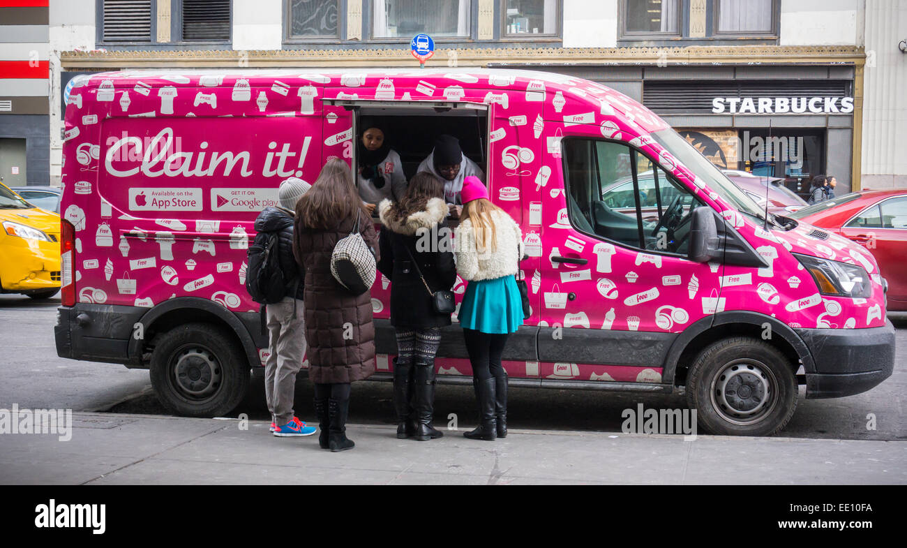 A promotional van for the mobile app 'Claim It!' is parked in New York on Sunday, January 11, 2015. The start-up with apps for iOs with Android in production gives away 'free stuff' in exchange for watching a short advertising video. Mobile users put a 'claim' in for offers and wait for the weekly drawing to claim whatever they have won. They also use beacons to determine if you are close and have various promotions running out of the truck.  (© Richard B. Levine) Stock Photo