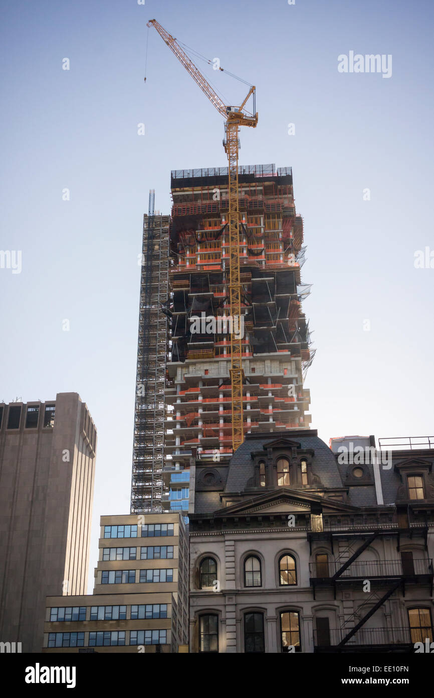 The condo skyscraper at 56 Leonard Street looms over older buildings in Tribeca in New York on Sunday, January 11, 2015. Designed by Herzog & de Meuron the condo will eventually rise to 820 feet with 145 apartments, many already in contract. (© Richard B. Levine) Stock Photo
