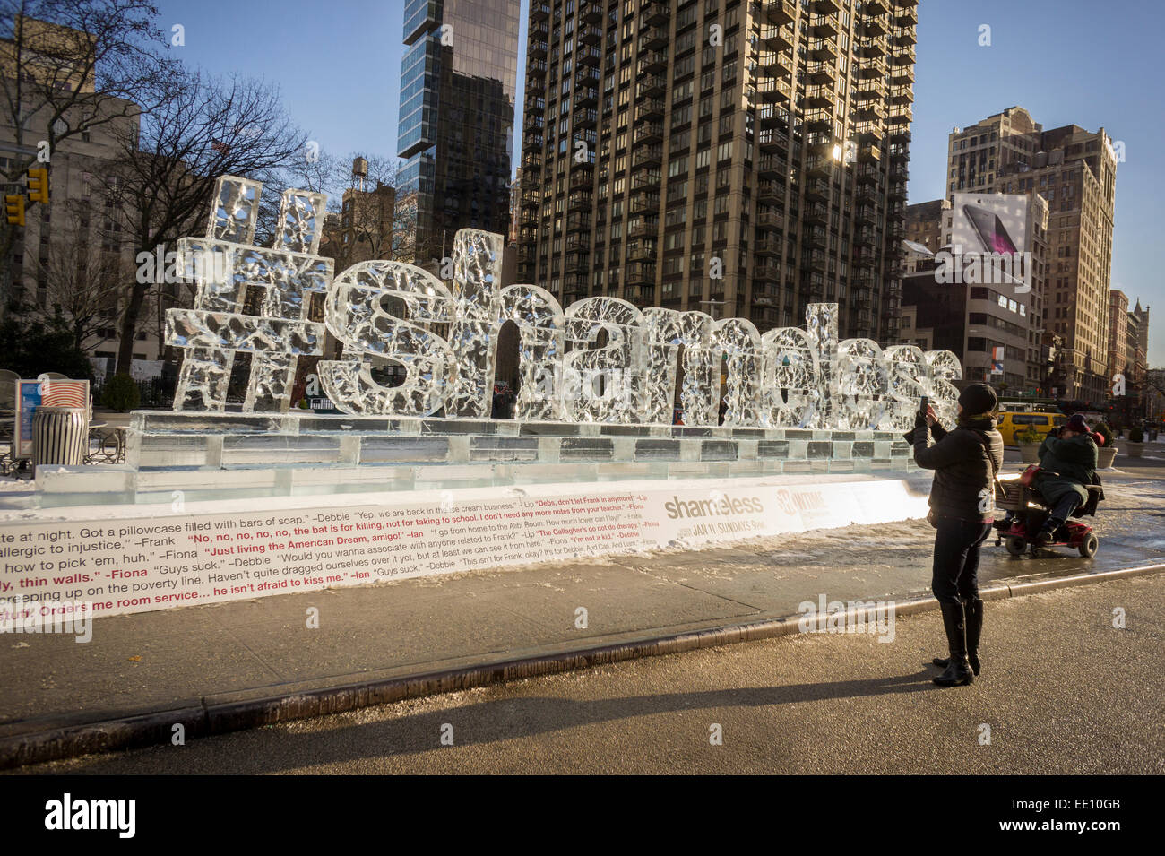 Passer by amuse themselves with an ice sculpture promoting the Showtime series 'Shameless' is displayed in Madison Square in New York on Friday, January 9, 2015. The fifth season of the cable television show starts on Sunday.   (© Richard B. Levine) Stock Photo