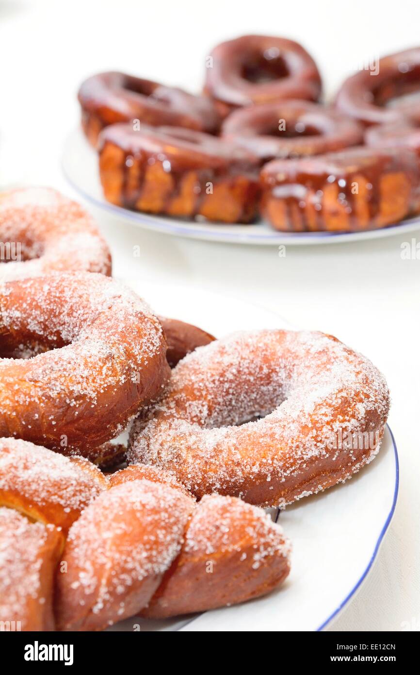 Sweet donuts on the plate with sugar and chocolate glaze. Stock Photo