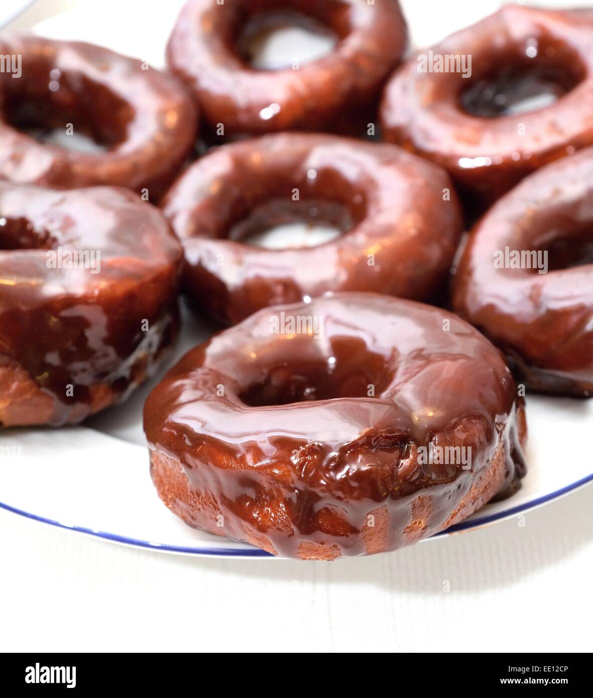 Sweet donuts on the plate with chocolate glaze. Stock Photo