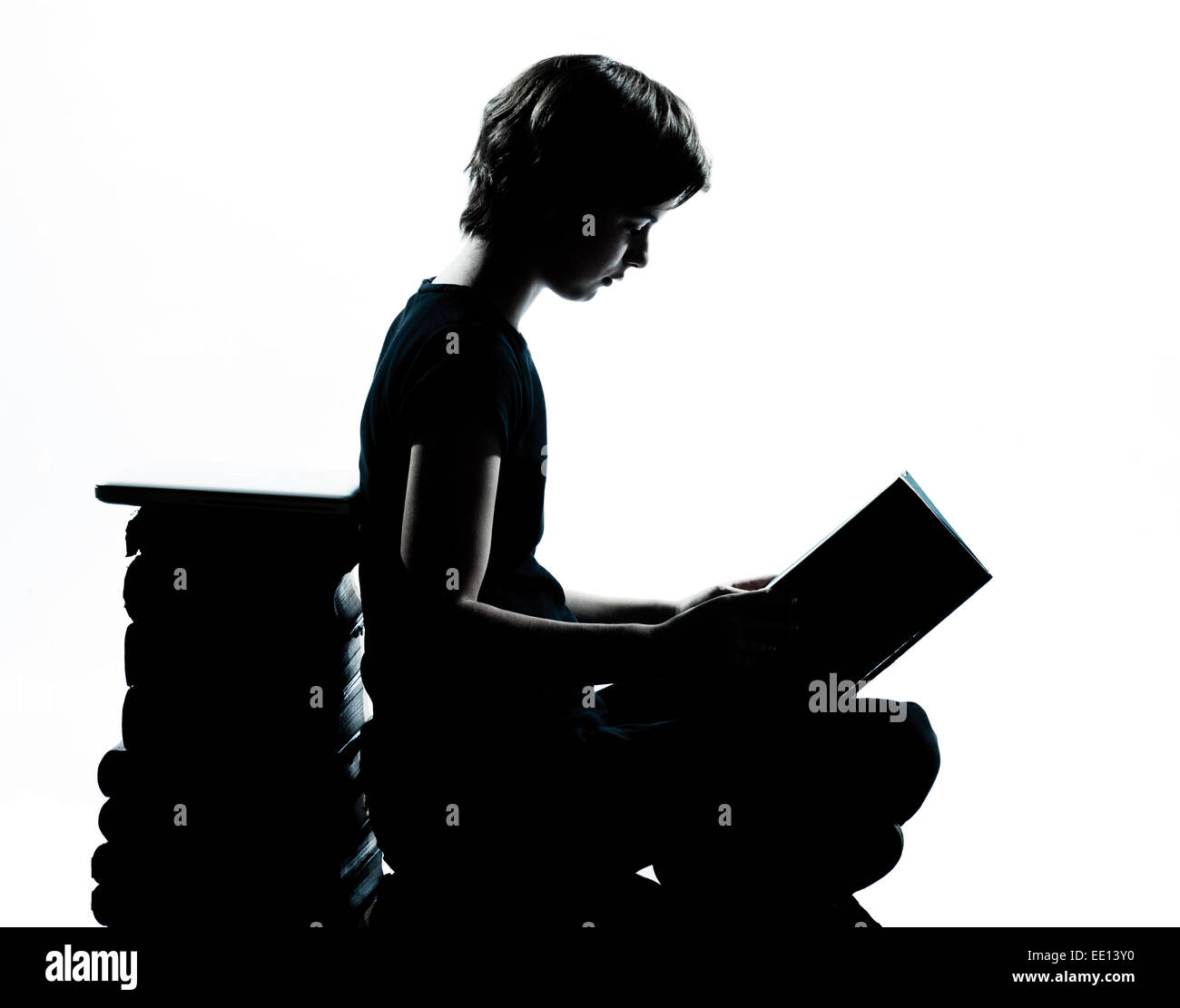 one caucasian young teenager silhouette boy or girl reading full length in studio cut out isolated on white background Stock Photo