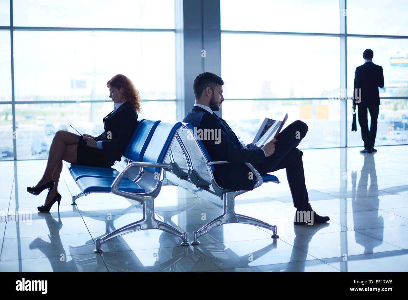 Business people reading periodicals in the airport Stock Photo