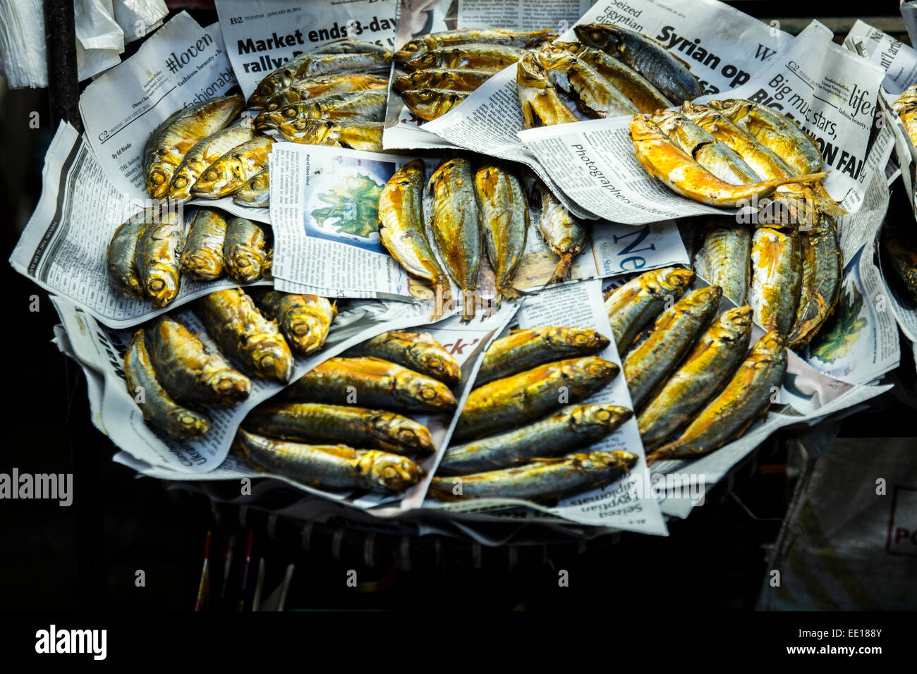 Smoked fish snack on old newspaper pages in the Baguio City Market in