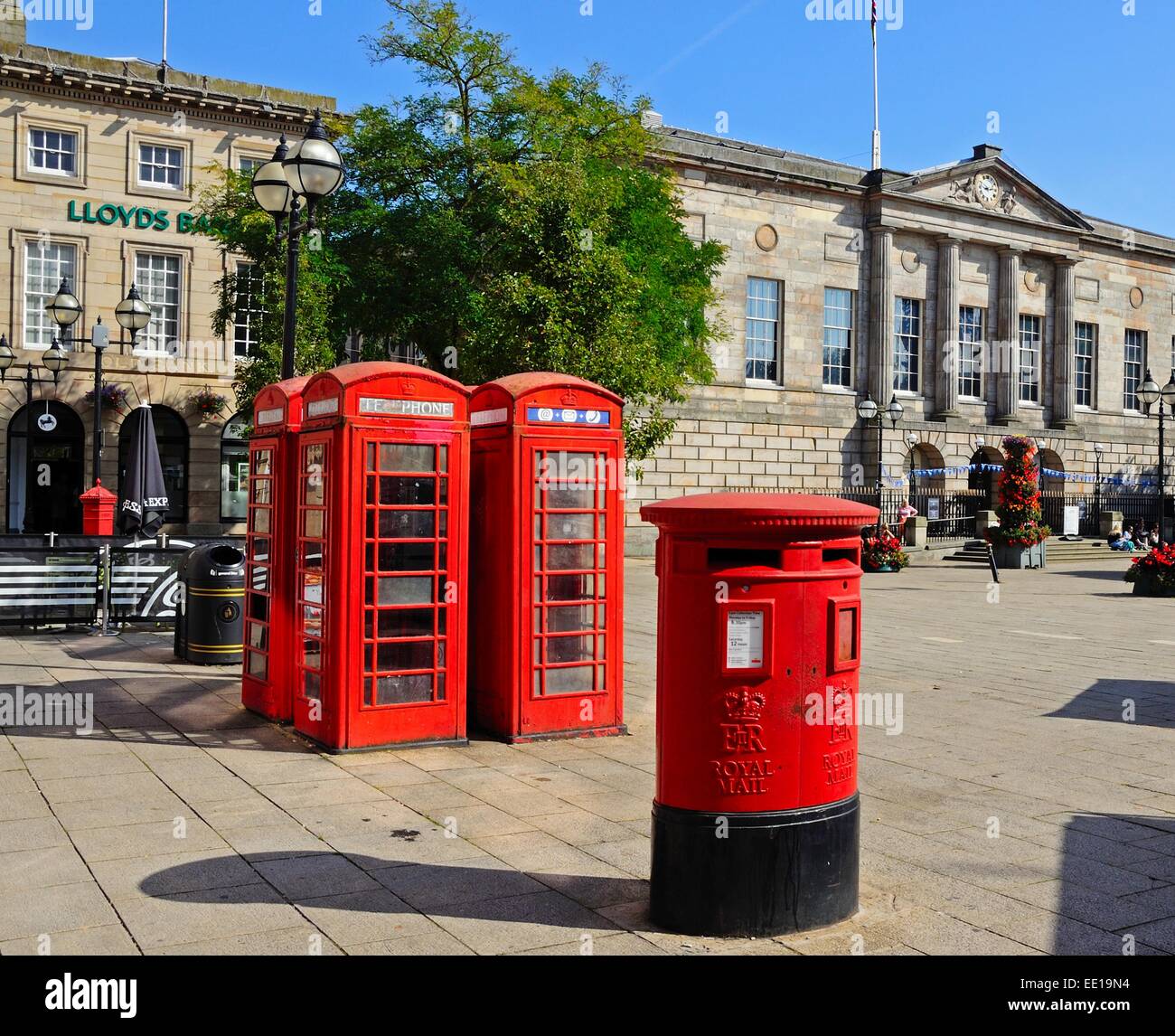 Red post box and telephone boxes with the Shire Hall Gallery to the rear in Market Square, Stafford, Staffordshire, England, UK, Stock Photo