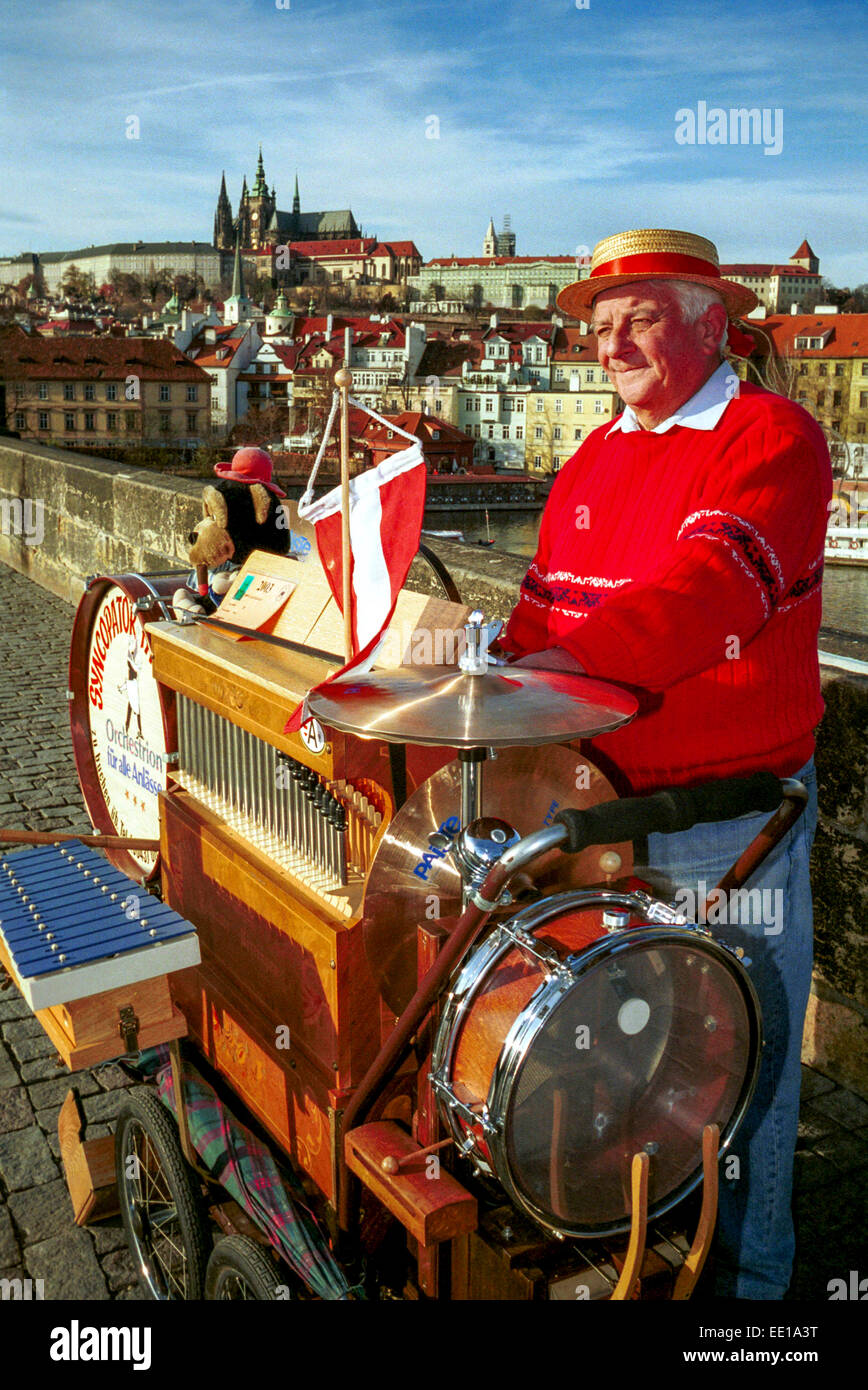 Musician on a barrel organ, Prague  Charles Bridge Prague Castle Czech Republic musical instruments Stock Photo