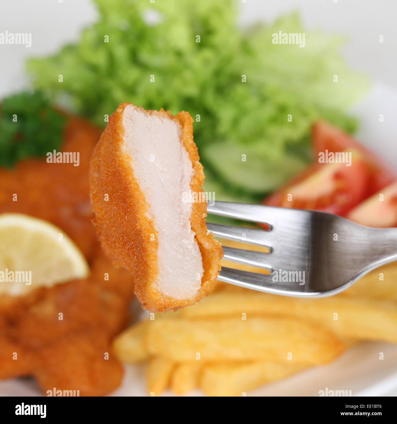 Eating Schnitzel chop cutlet steak with fork Stock Photo