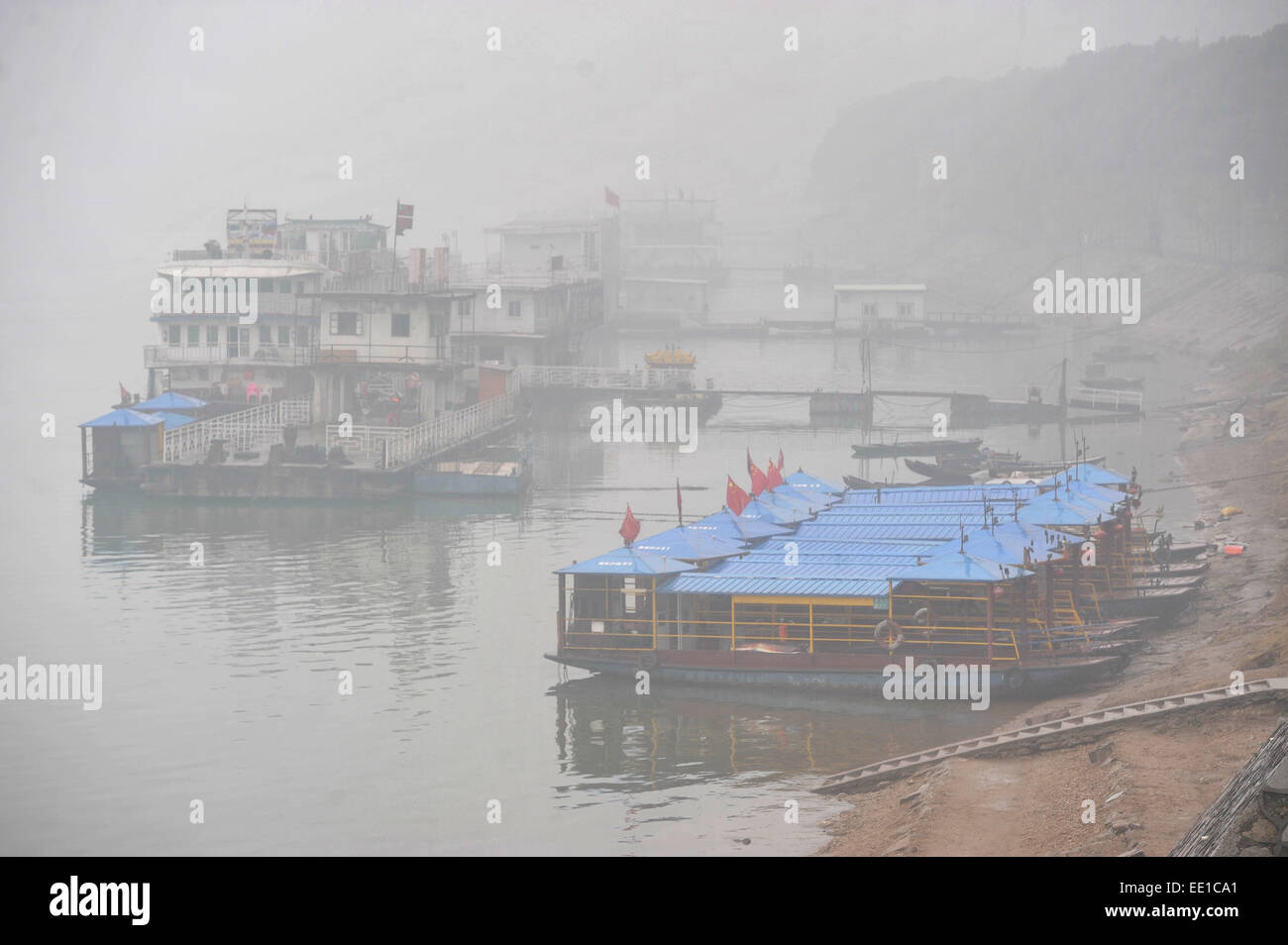 Changsha, China's Hunan Province. 13th Jan, 2015. Ships are anchored by the smog-shrouded Xiangjiang River in Changsha, capital of central China's Hunan Province, Jan. 13, 2015. Credit:  Long Hongtao/Xinhua/Alamy Live News Stock Photo