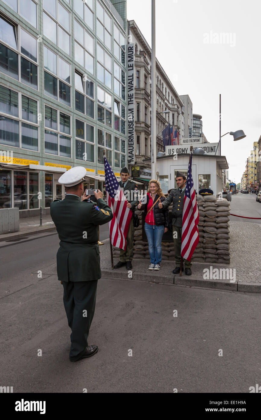 Tourist has photo taken with uniformed actor border guards, Checkpoint Charlie, Mitte, Berlin, Germany, Europe Stock Photo