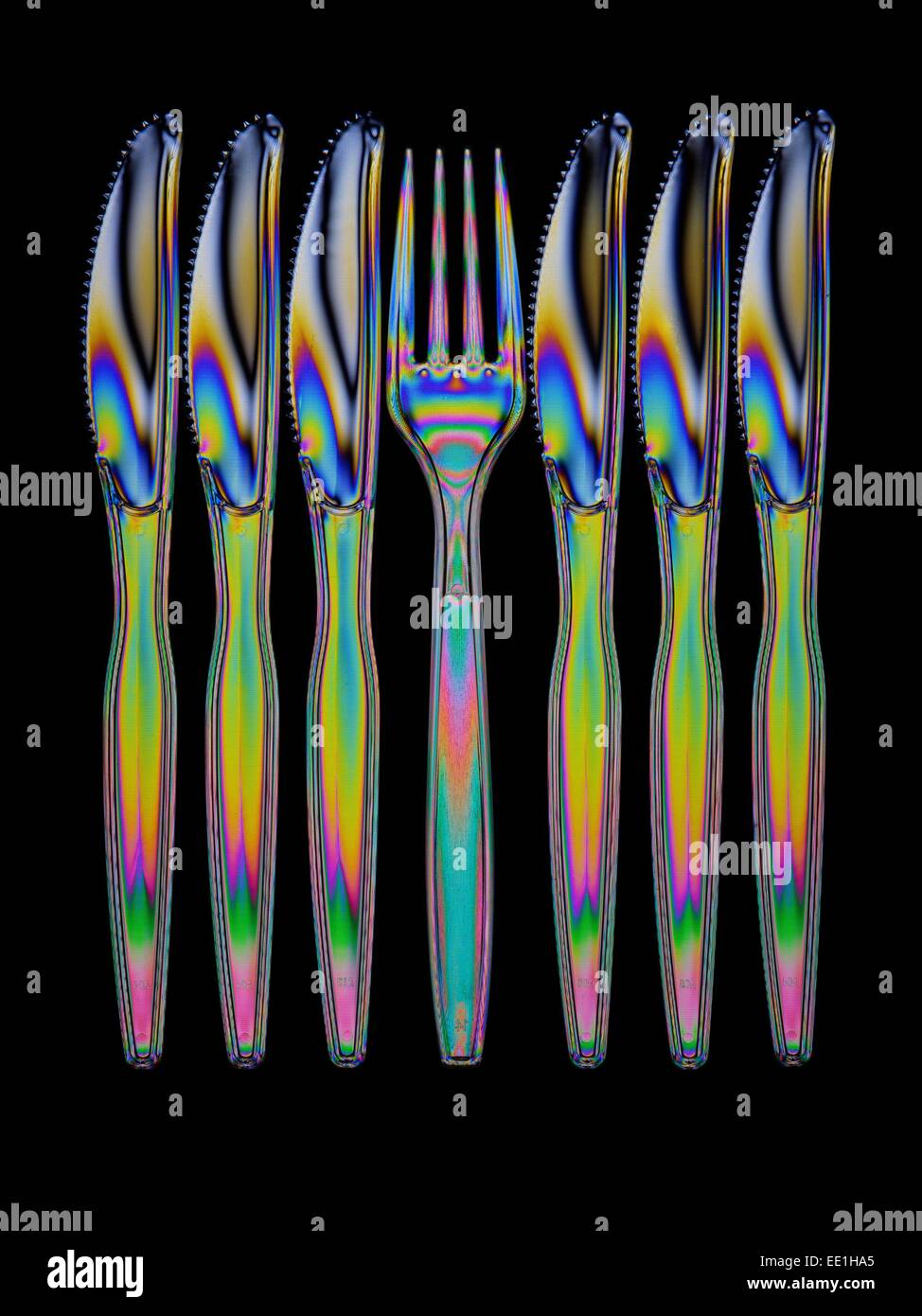 Clear plastic cutlery photographed through polarising filters. Stock Photo