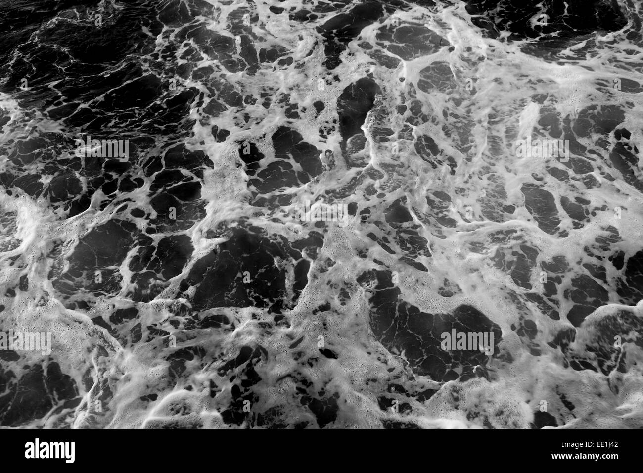 Waves crashing rocks beach in Black and White Stock Photos & Images - Alamy