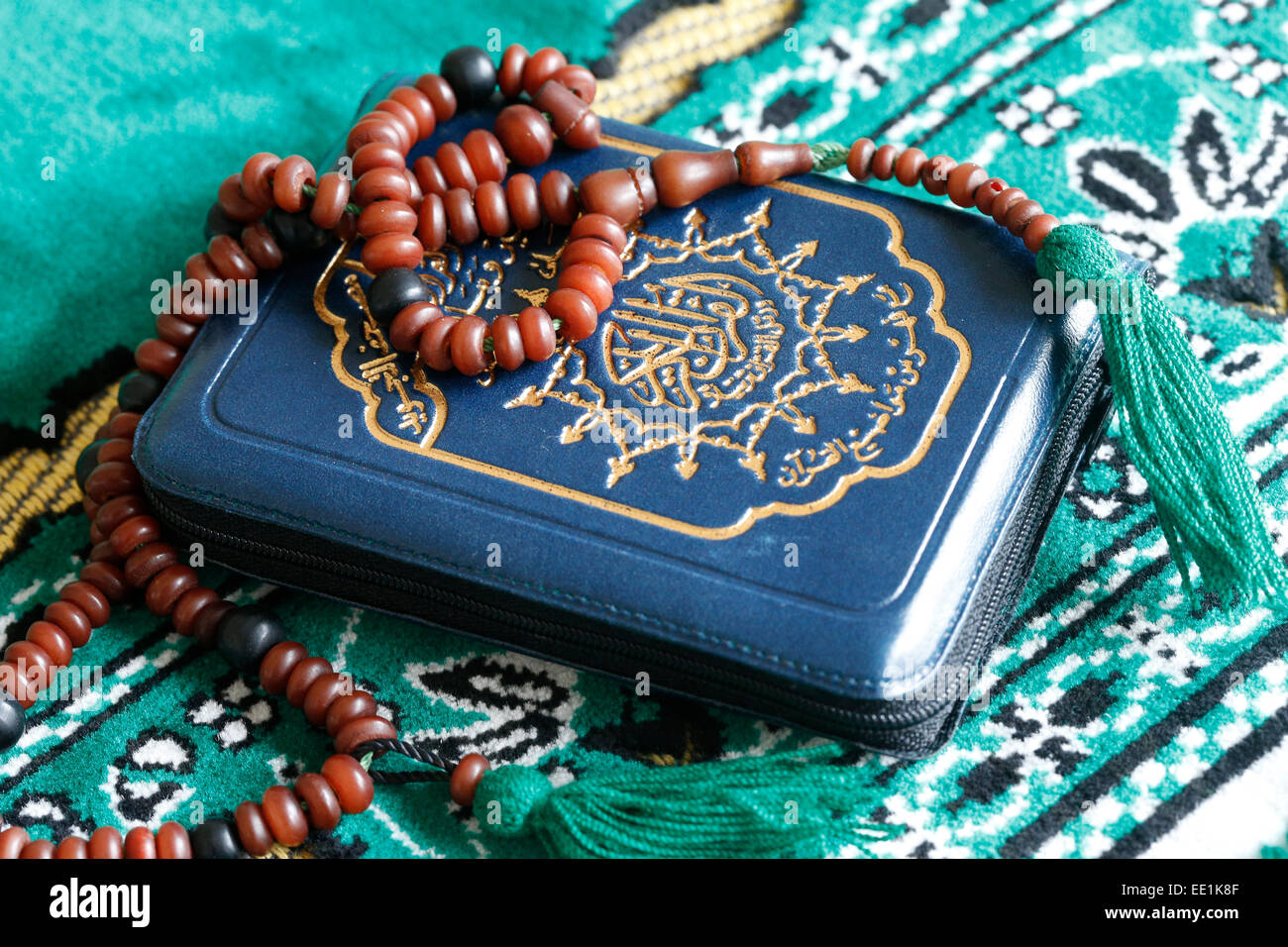 Quran and Islamic prayer beads on a prayer mat, Paris, France, Europe Stock Photo