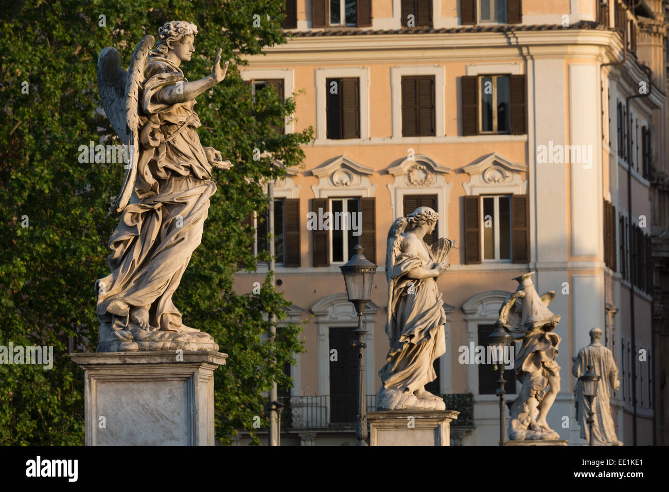 Angel statues on Ponte Sant' Angelo with grand house behind, Rome, Lazio, Italy, Europe Stock Photo