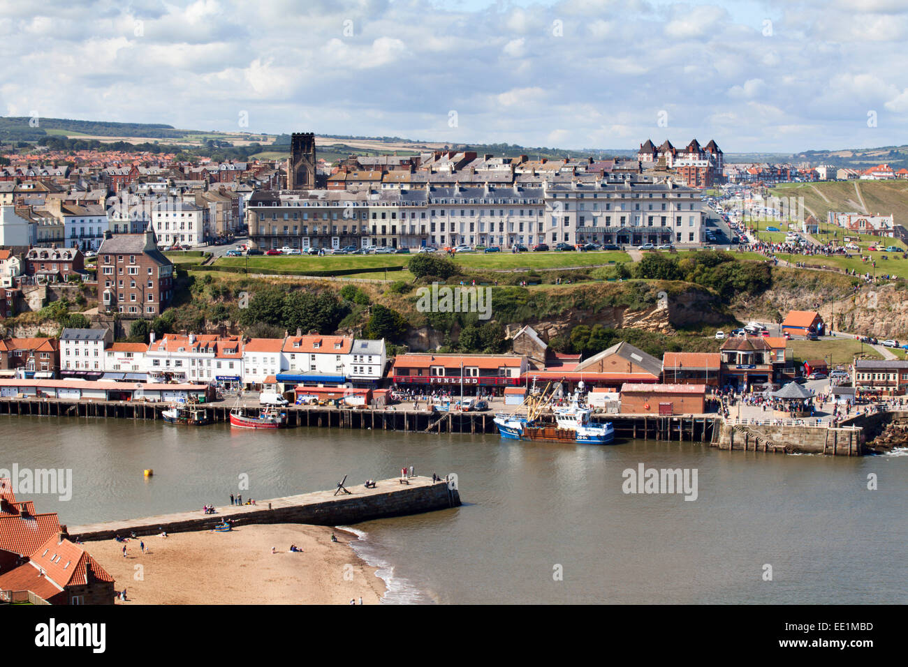 Tate Hill Pier and the West Cliff with St. Hilda's Church, Whitby, Yorkshire, England, United