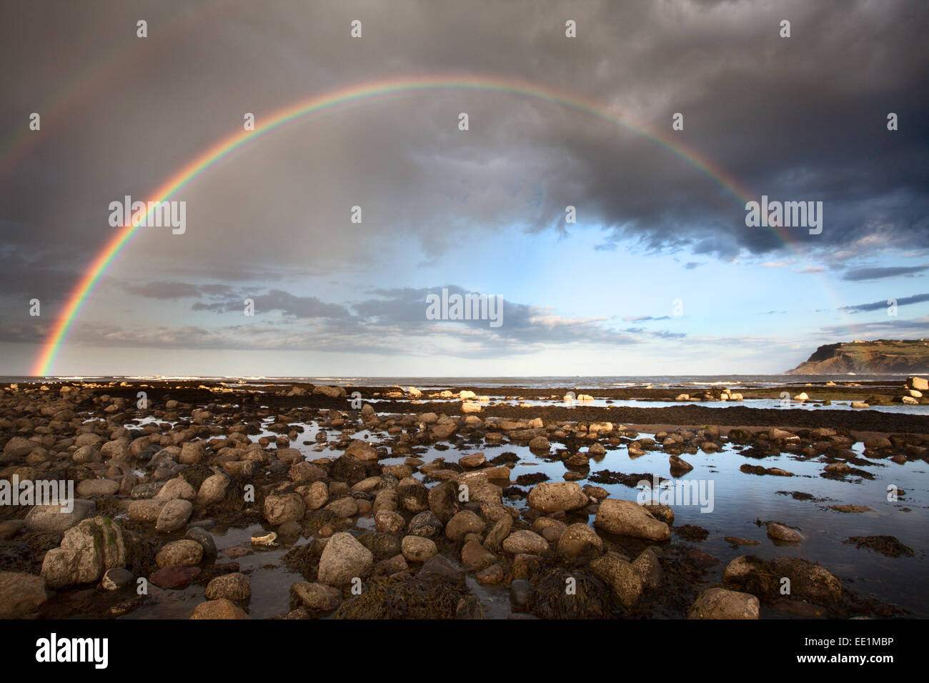 Rainbow over the sea at Robin Hoods Bay, Yorkshire, England, United Kingdom, Europe Stock Photo