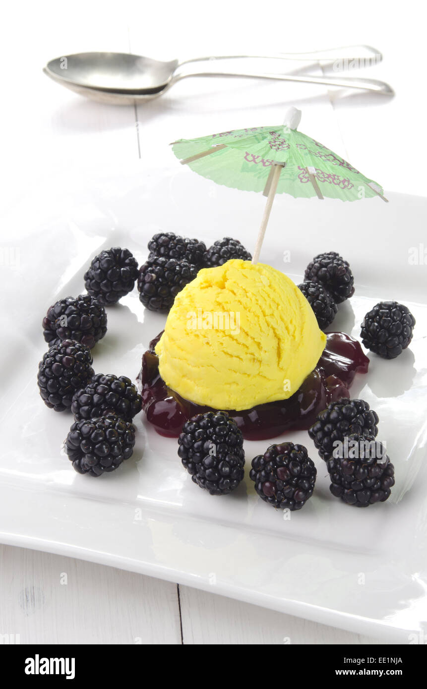 lemon ice cream with fresh blackberries on a white plate Stock Photo