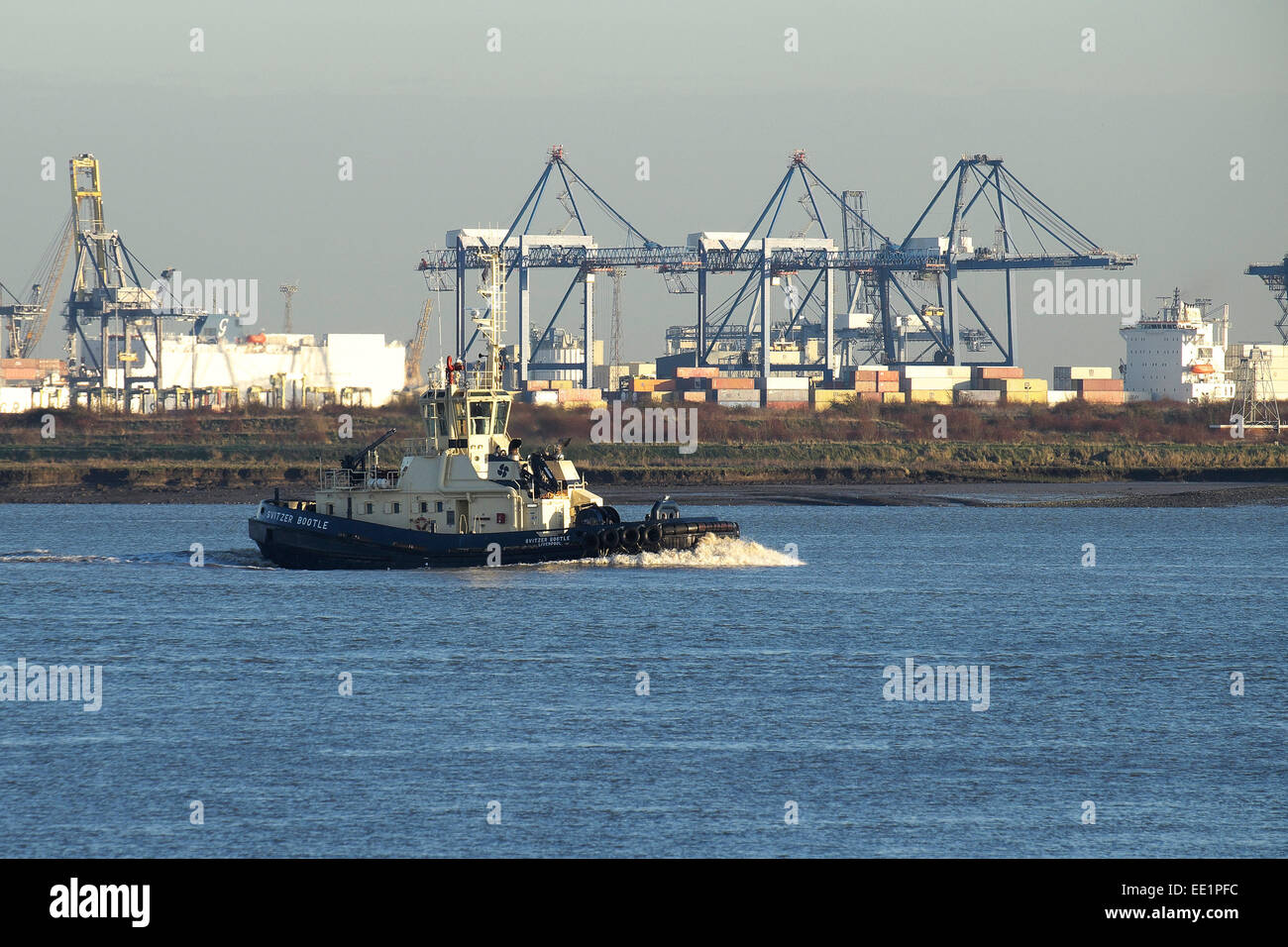 The tug, Svitzer Bootle, steaming upriver on the River Thames. Stock Photo