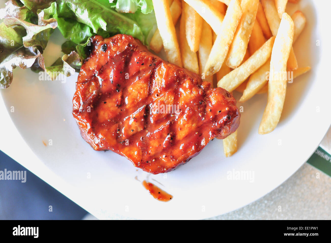 Pork loin steak in a dish Serve with French fries Stock Photo Alamy