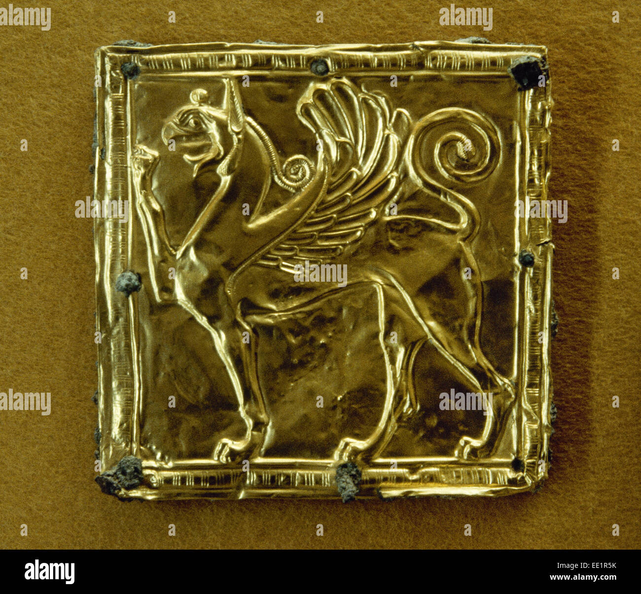 Greek Art. Gold plate depicting a winged griffin. 6th century B.C. Archeological Museum. Delphi. Greece. Stock Photo