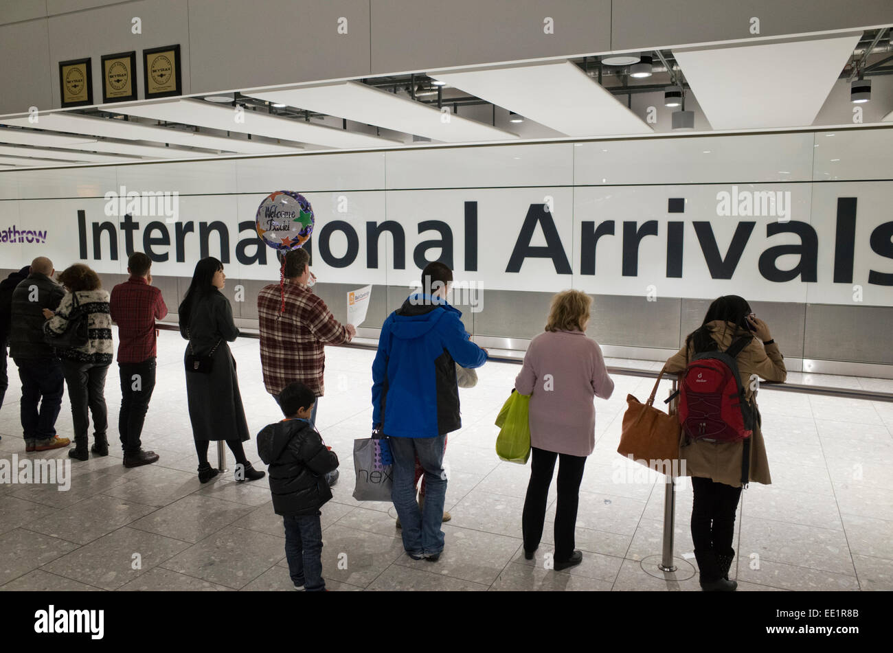 People waiting at International Arrivals at Heathrow airport in Britain Stock Photo