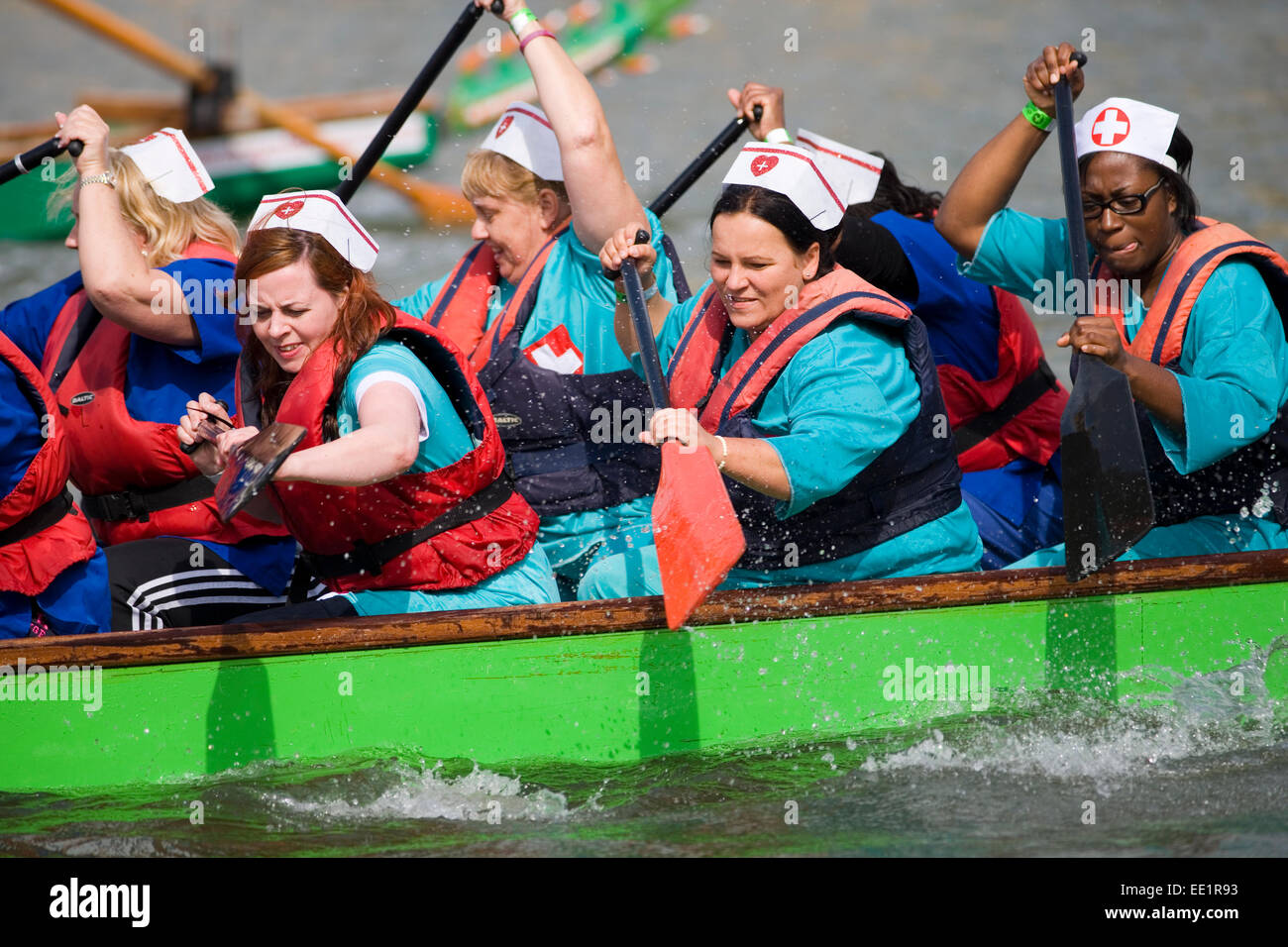 Competitors dressed as nurses during a Dragon Boat race, Bristol. Stock Photo