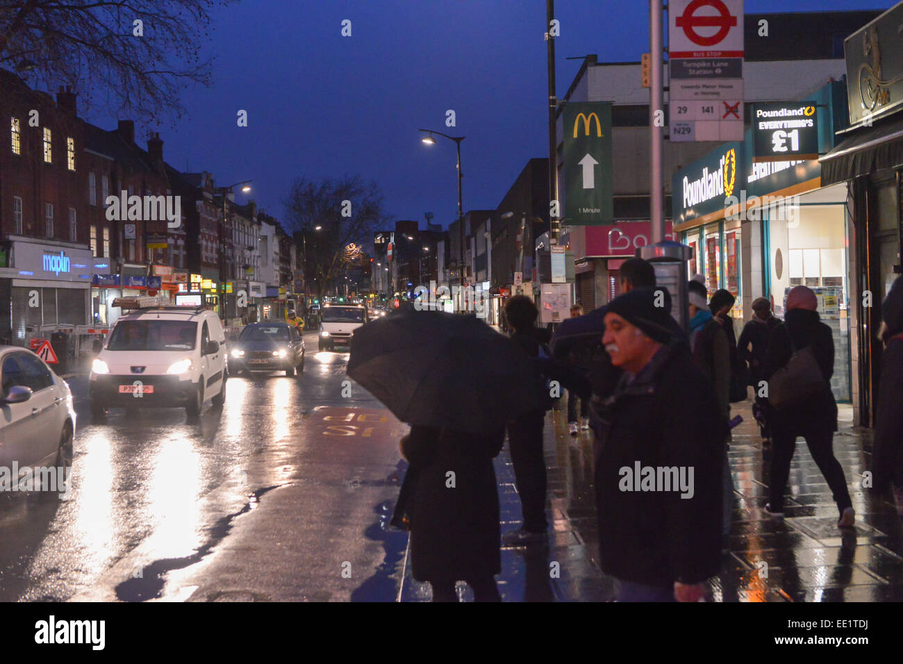 Turnpike Lane, London, UK. 13th January 2015. Passengers wait for the few buses running at Turnpike Lane as the London bus strike over pay begins. Credit:  Matthew Chattle/Alamy Live News Stock Photo