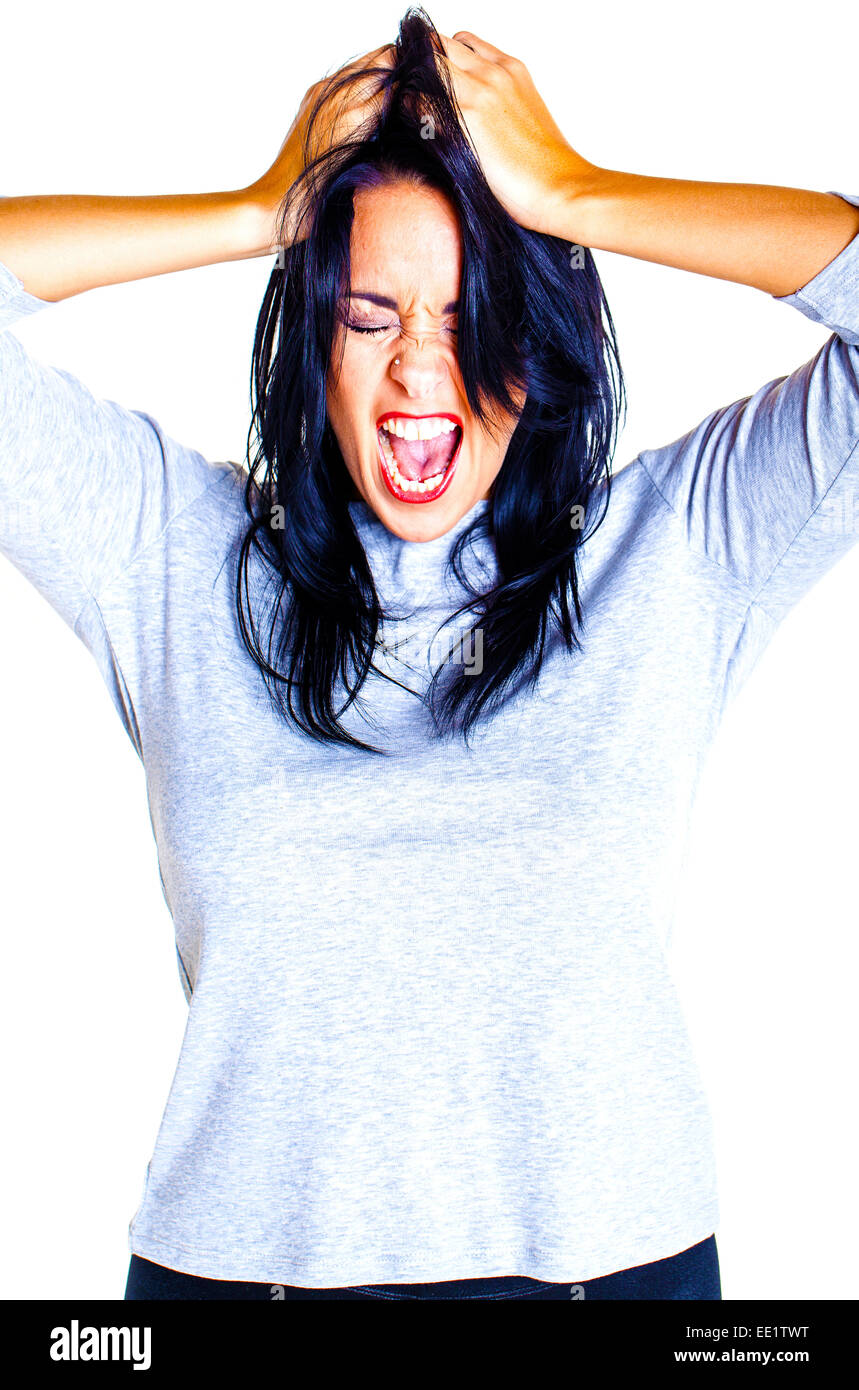 Young woman showing her anger towards someone over a white background. Stock Photo