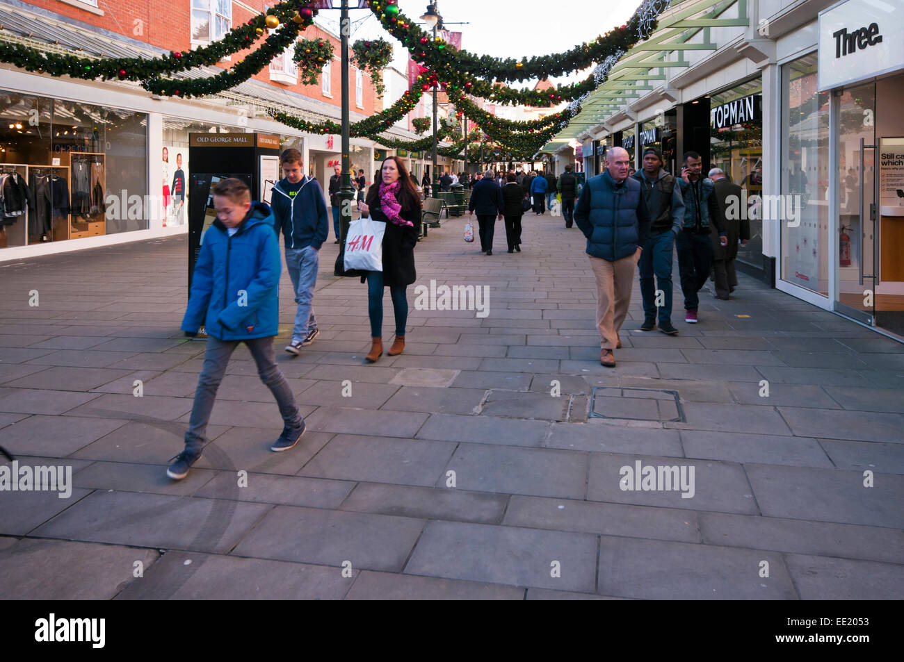Christmas Shoppers Shopping In Old George Mall Salisbury Wiltshire at Xmas Stock Photo