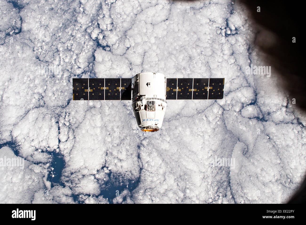 The SpaceX Dragon commercial cargo craft approaches the International Space Station for grapple and berthing January 12, 2015 in Earth Orbit. Dragon will spend the next four weeks attached to the Harmony node as the Expedition 42 crew unloads supplies, hardware, experiments, and computer gear and equipment. Stock Photo