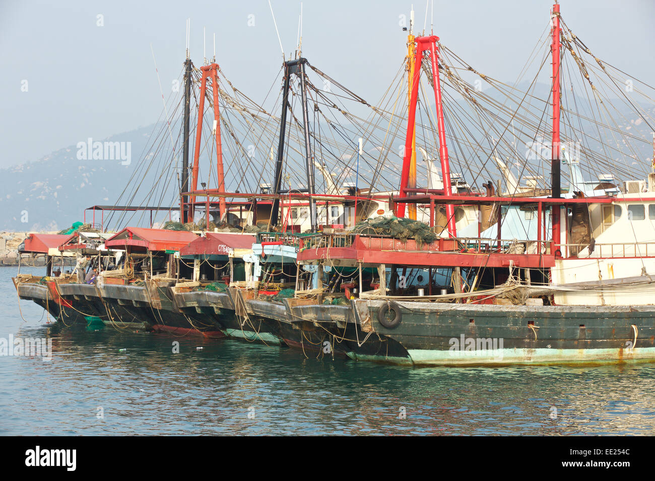 Fleet Of Commercial Fishing Boats Laid-Up On Cheung Chau Island, Hong Kong. Stock Photo