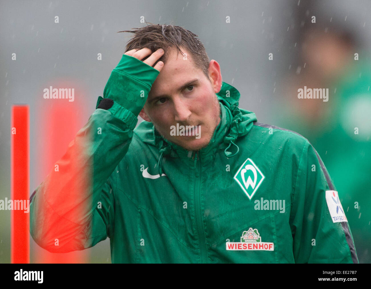 Belek, Turkey. 13th Jan, 2015. Werder Bremen's player Izet Hajrovic wipes the rain from his face during a training session in Belek, Turkey, 13 January 2015. Werder Bremen stays in Belek to prepare for the second half of the German Bundesliga season. Photo: Soeren Stache/dpa/Alamy Live News Stock Photo