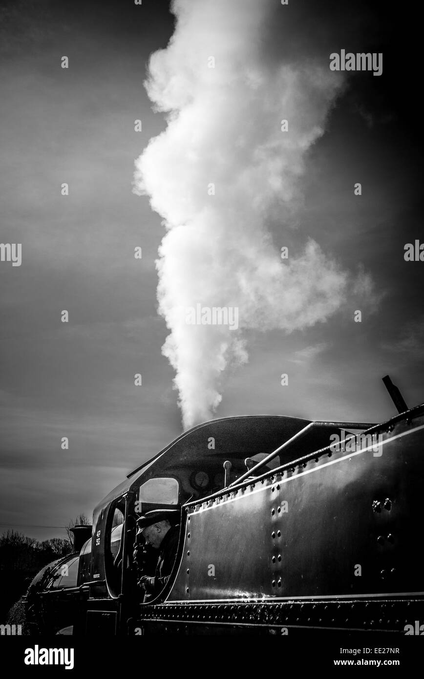 A SOMERSET & DORSET JOINT RAILWAY 7F CLASS 2-8-0 locomotive run by the West Somerset Railway (WSR), venting steam in Watchet. Stock Photo