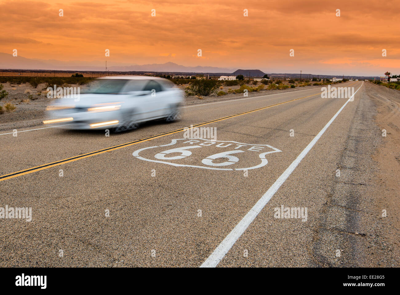 U.S. Route 66 horizontal road sign in sunset desert landscape, Amboy, California, USA Stock Photo