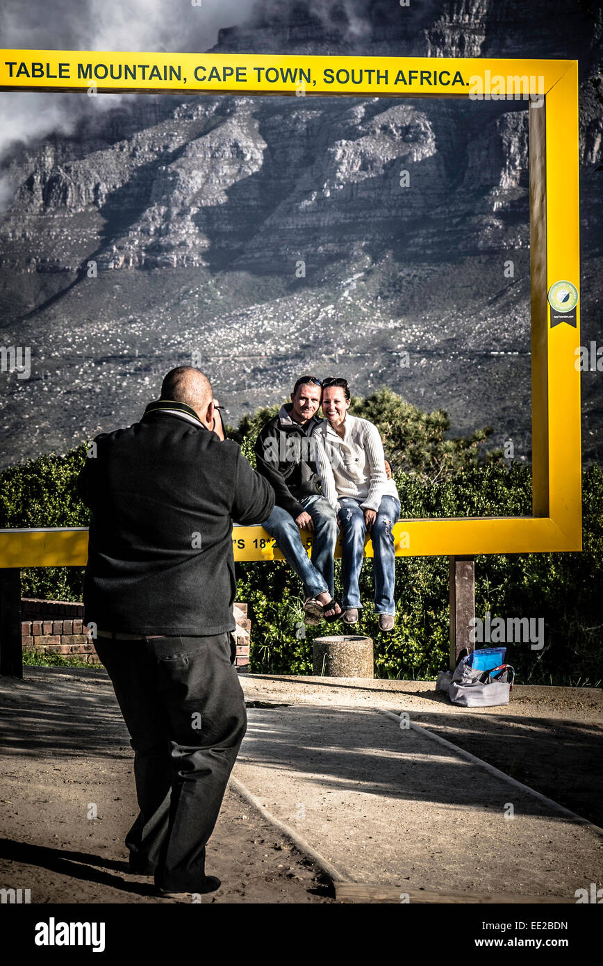 A couple being photographed in one of the six Table Mountain Frames, (this one is on Signal Hill) in Cape Town, South Africa. Stock Photo