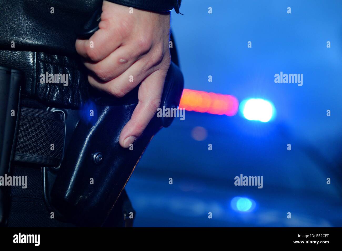 A policeman grabs his pistol, Germany, city of Braunlage, 12. January 2015. Photo: Frank May Stock Photo