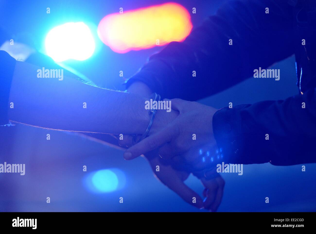 A man is getting handcuffs, Germany, city of Braunlage, 12. January 2015. Photo: Frank May Stock Photo