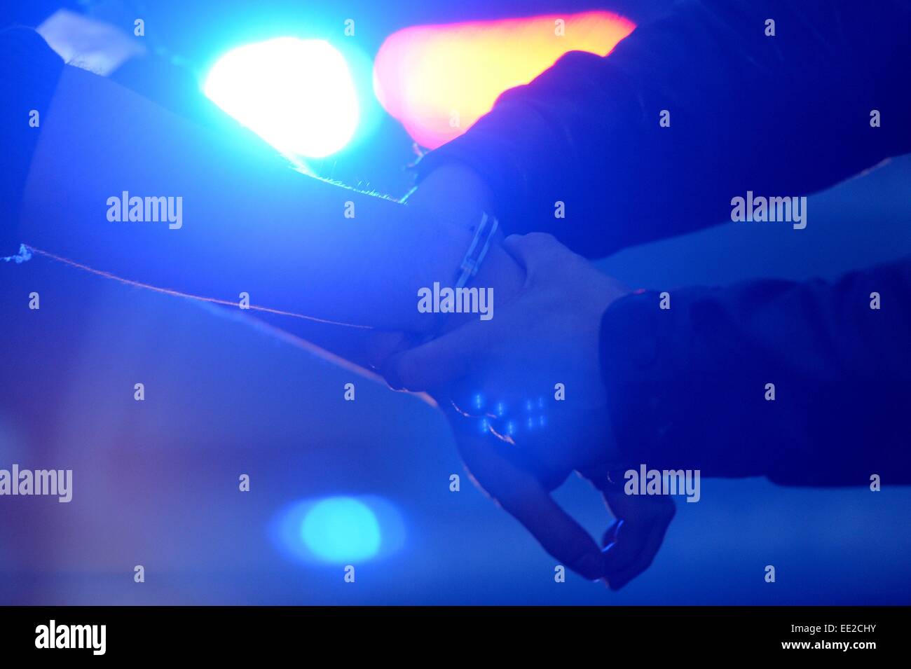 A man is getting handcuffs, Germany, city of Braunlage, 12. January 2015. Photo: Frank May Stock Photo