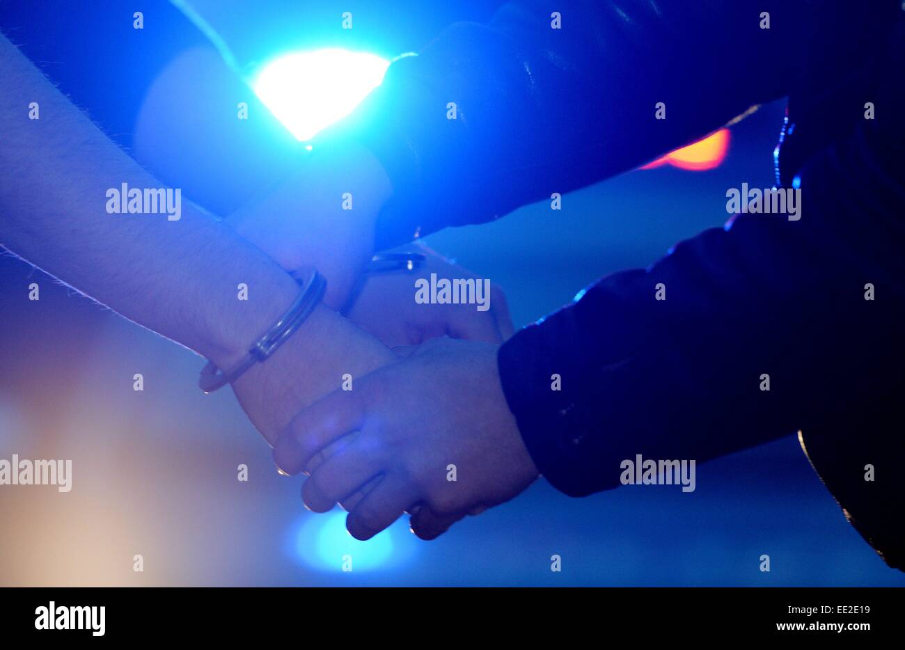 A man is getting handcuffs, Germany, city of Braunlage, 12. January 2015. Photo: Frank May Stock Photo