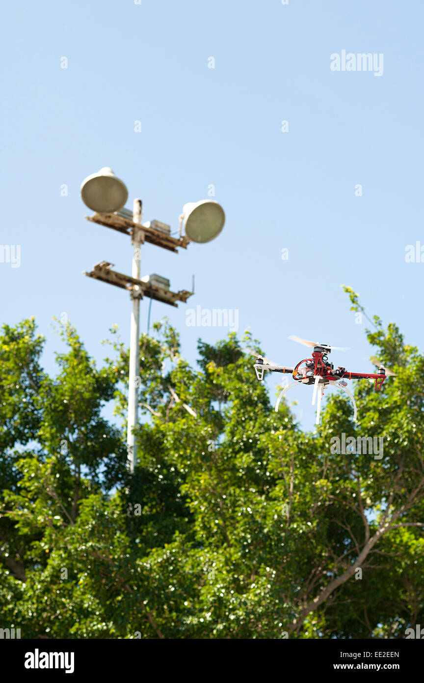 Drone flies safely through gap in trees before landing on the outskirts of Cartagena, Colombia. Stock Photo
